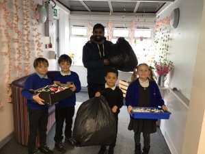 Children proudly handing our recycling over to COG