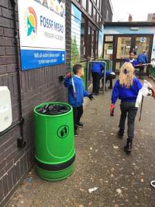 Children proudly litter picking to keep our school clean. 